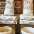 Stacked bags and buckets of HG Matthews Lime Mortars and Renders Range